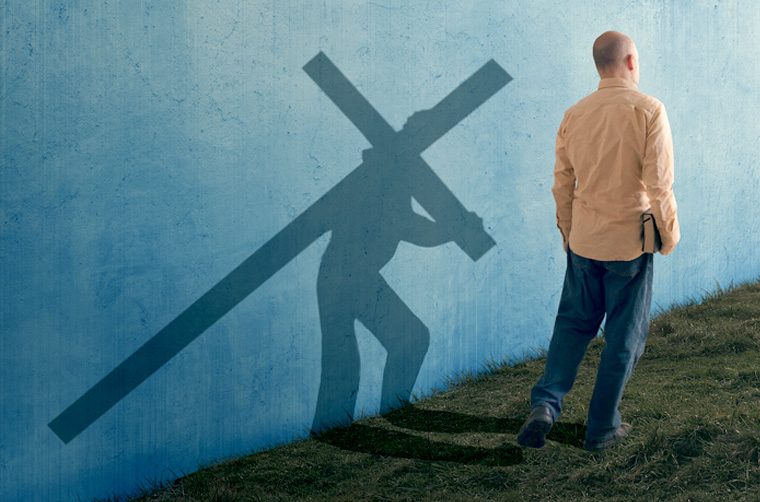 Man walking/shadow man carrying cross